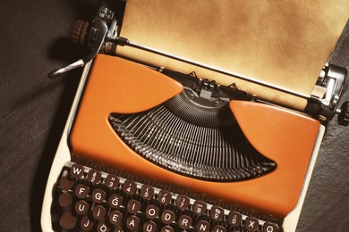Image of Old vintage typewriter with paper on grey table, top view