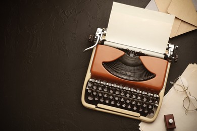 Image of Old vintage typewriter with paper on writer's table, top view. Space for text