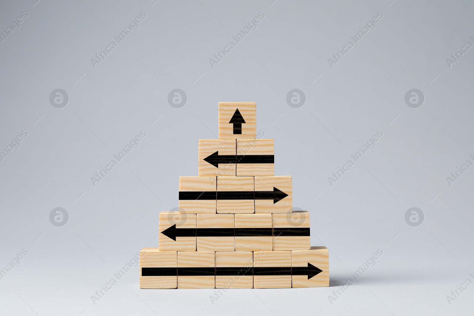 Image of Wooden cubes with black arrows on white table