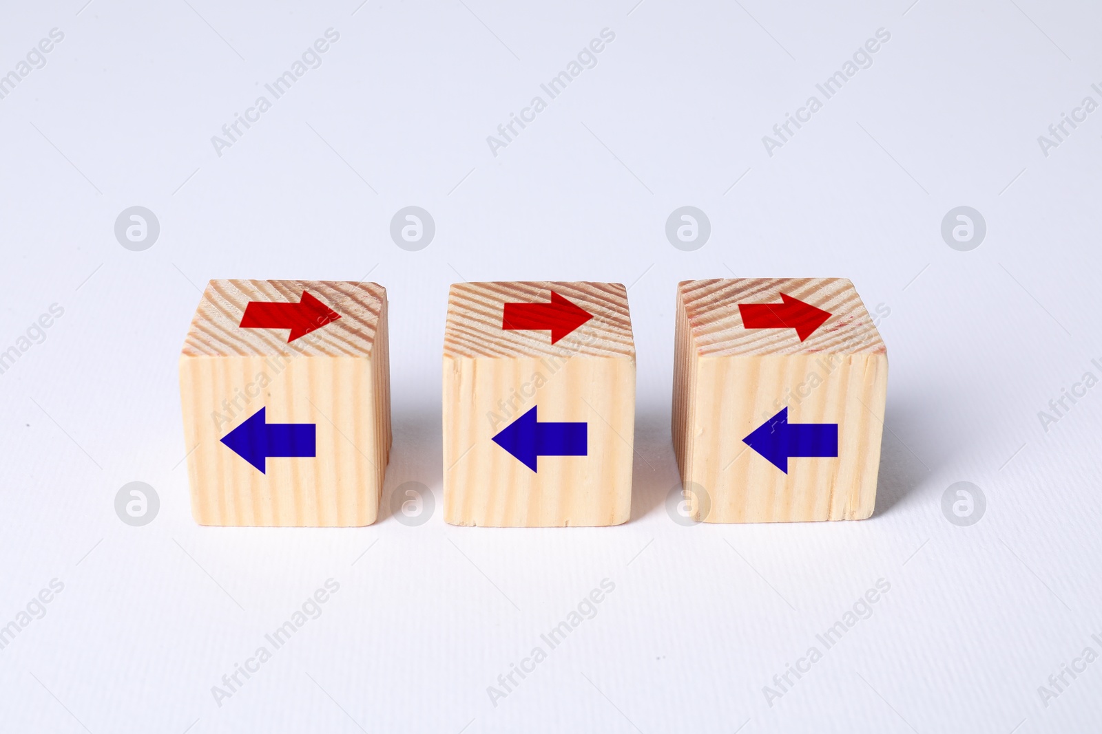 Image of Wooden cubes with red and blue arrows on white background