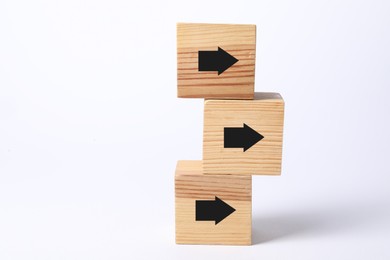 Image of Wooden cubes with black arrows on white background