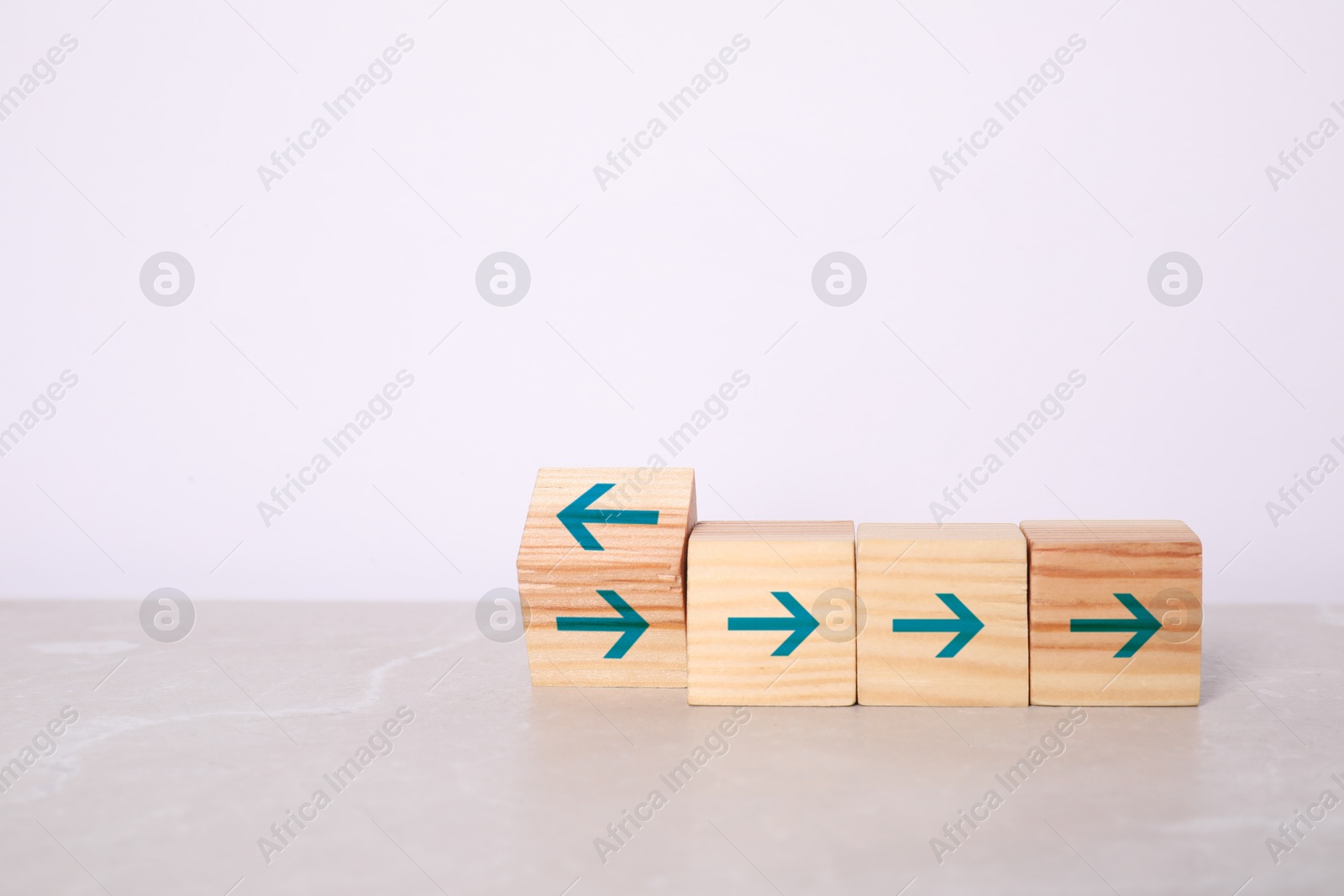 Image of Wooden cubes with blue arrows on table