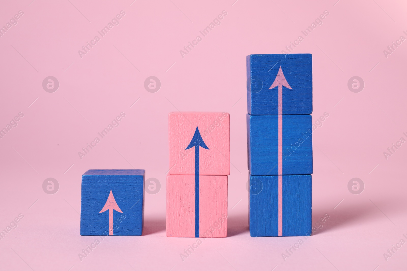 Image of Colorful cubes with arrows on pink background