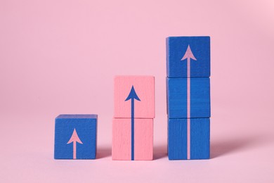 Image of Colorful cubes with arrows on pink background