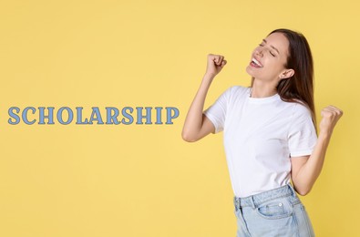 Image of Scholarship. Happy student and word on yellow background