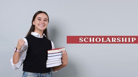 Image of Scholarship. Happy young student with stack of books on light grey background, banner design