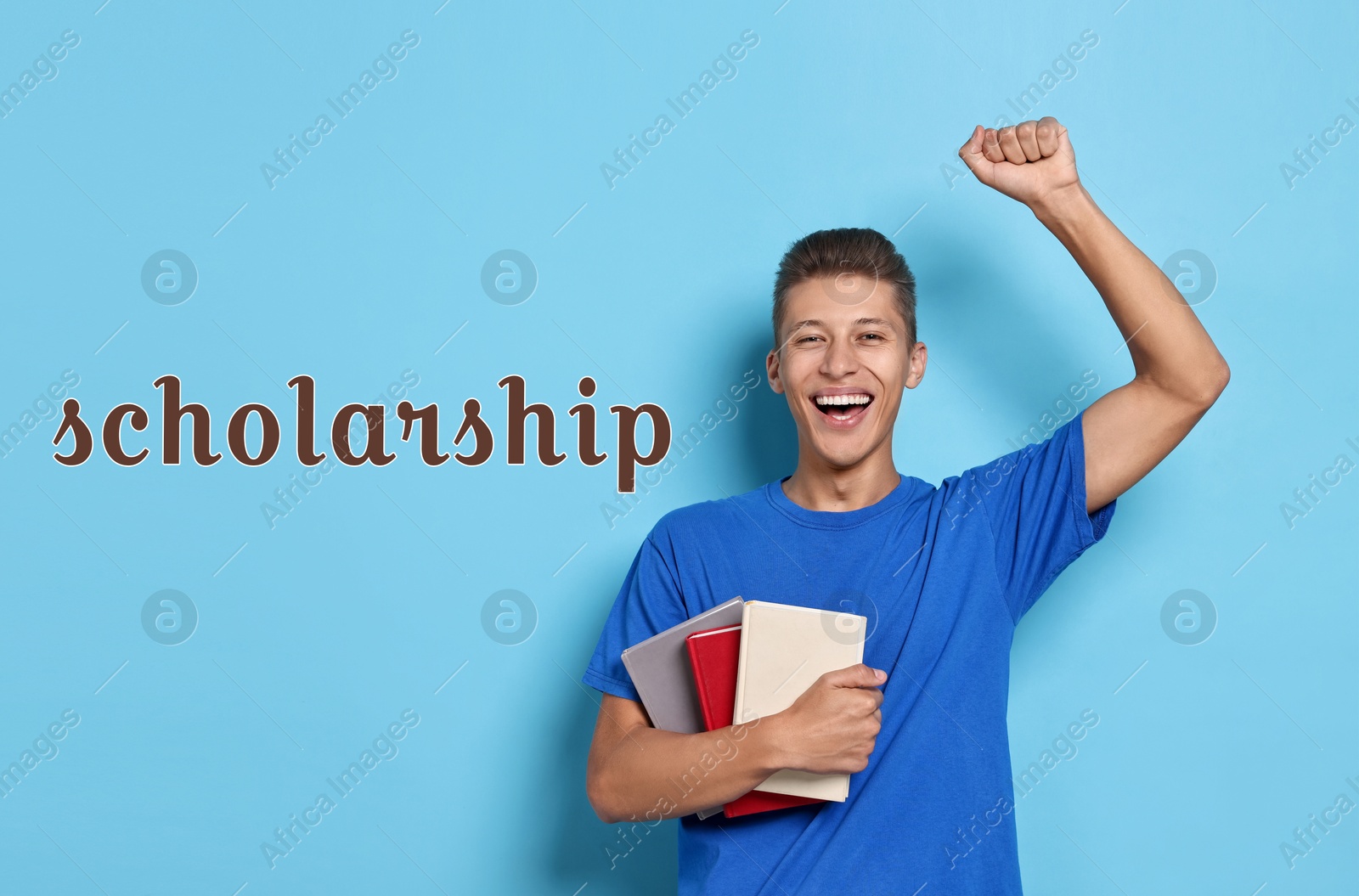 Image of Scholarship. Happy young student with books on light blue background