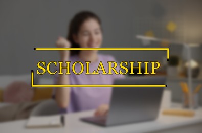 Image of Scholarship. Happy student with laptop at table, blurred view