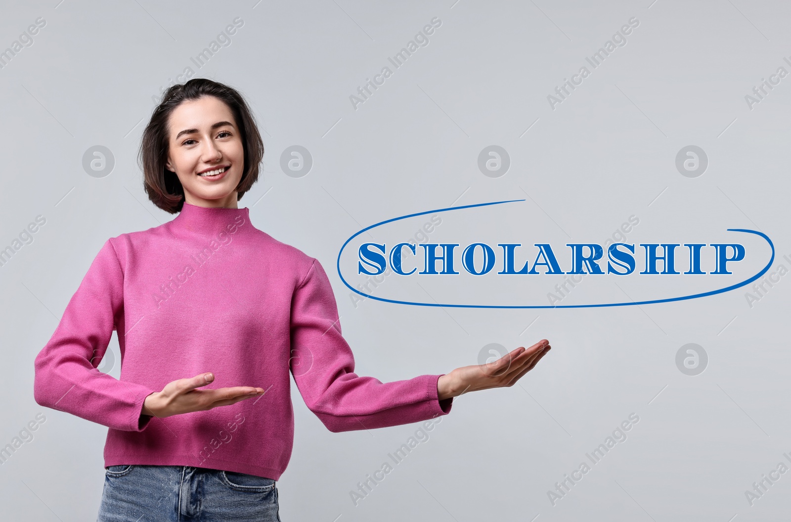 Image of Scholarship. Happy student pointing at word on light grey background