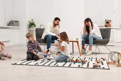 Photo of Hyperactive children playing and their overwhelmed parents at home