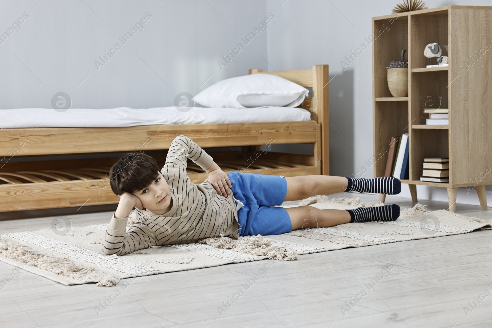 Photo of Little boy exercising at home. Morning routine