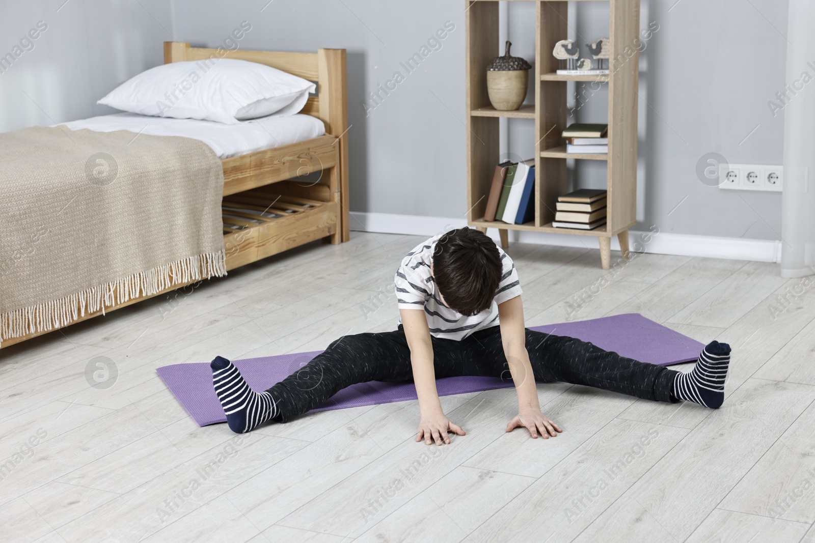 Photo of Little boy exercising at home. Morning routine