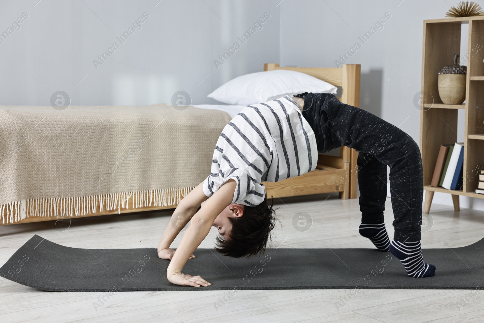 Photo of Little boy exercising at home. Morning routine