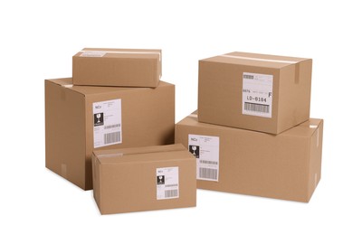 Photo of Many parcels with shipment labels isolated on white