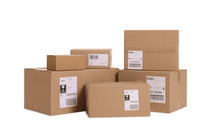 Photo of Many parcels with shipment labels isolated on white