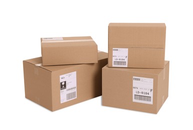 Photo of Many parcels with shipment labels isolated on white