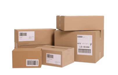 Photo of Many parcels with shipment labels isolated on white