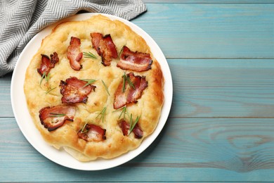 Photo of Delicious focaccia bread with bacon and rosemary on light blue wooden table, top view. Space for text