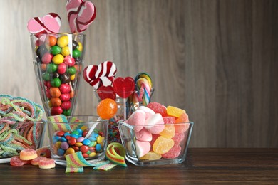 Photo of Candy bar. Many different tasty sweets on wooden table, space for text