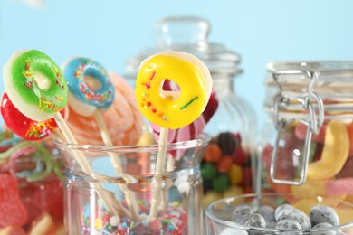 Photo of Candy bar. Many different sweets on light blue background, closeup