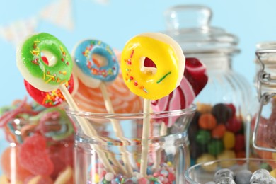 Photo of Candy bar. Many different sweets on light blue background, closeup