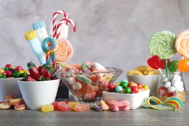 Photo of Candy bar. Many different sweets on wooden table against grey background