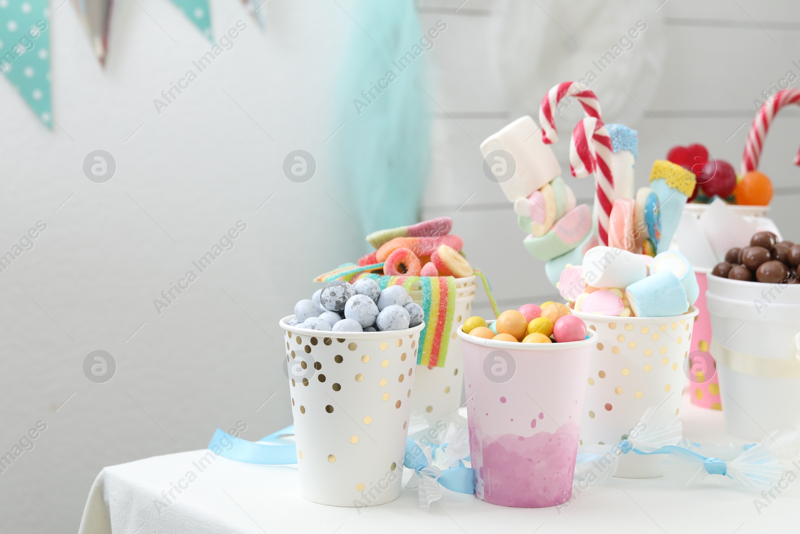 Photo of Candy bar. Different yummy sweets on white table indoors. Space for text