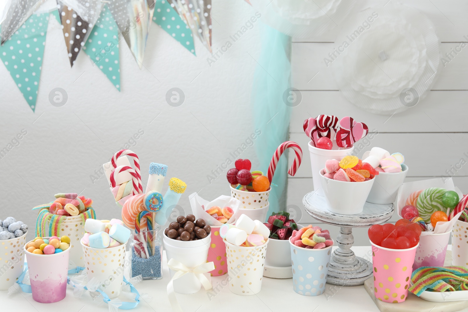 Photo of Candy bar. Different yummy sweets on white table indoors