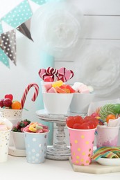 Photo of Candy bar. Different yummy sweets on white table indoors