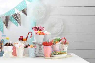 Photo of Candy bar. Different yummy sweets on white table indoors. Space for text