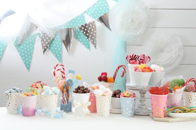 Photo of Candy bar. Different yummy sweets on white table indoors