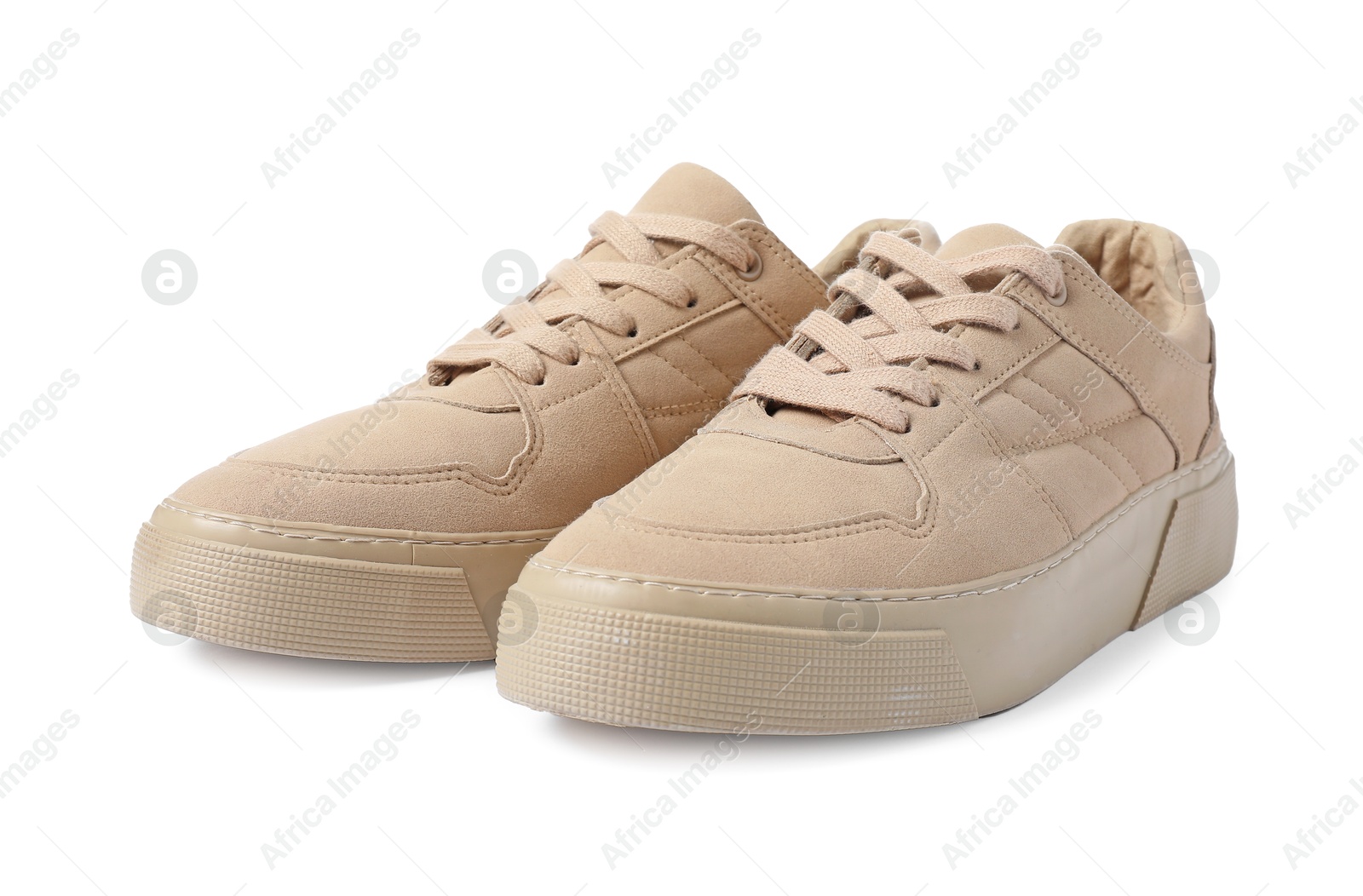 Photo of Pair of beige sneakers isolated on white. Sportive shoes