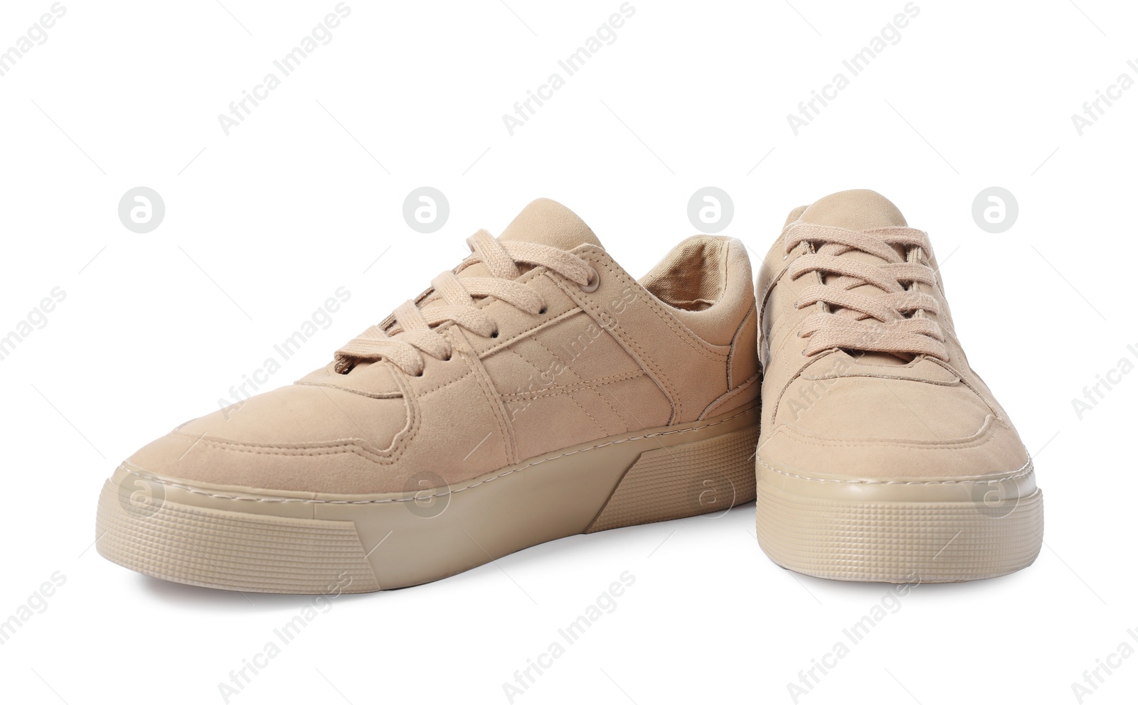 Photo of Pair of beige sneakers isolated on white. Sportive shoes