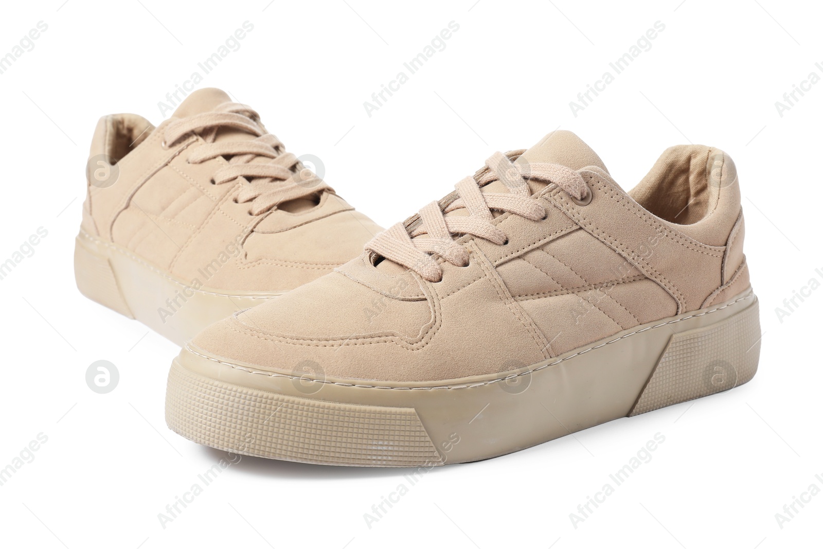 Photo of Pair of beige sneakers isolated on white. Sportive shoes