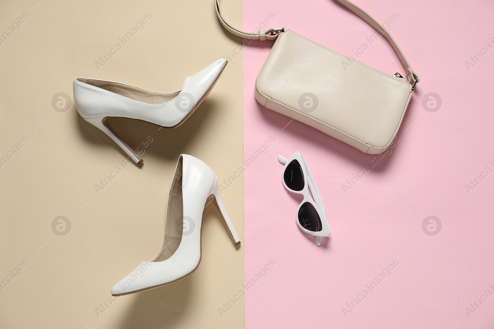 Photo of White high heeled shoes, bag and sunglasses on color background, flat lay