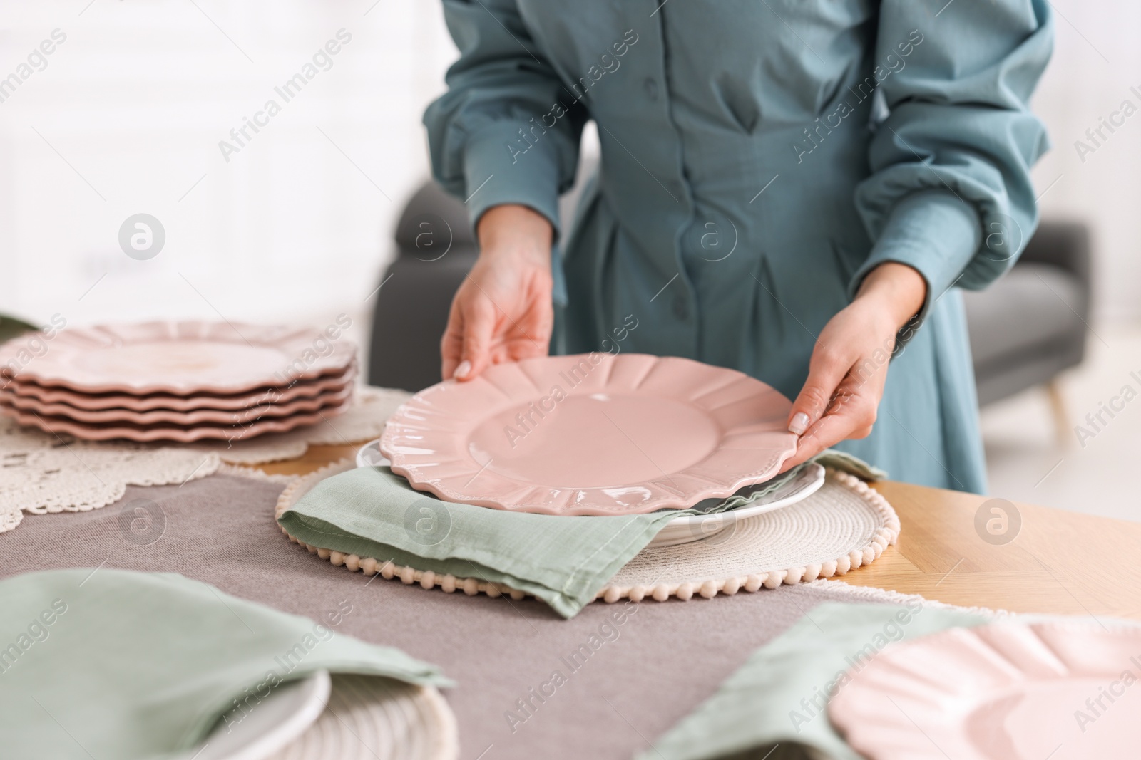 Photo of Woman setting table for dinner at home, closeup