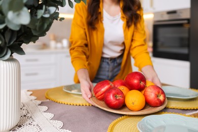 Photo of Woman setting table for dinner at home, closeup