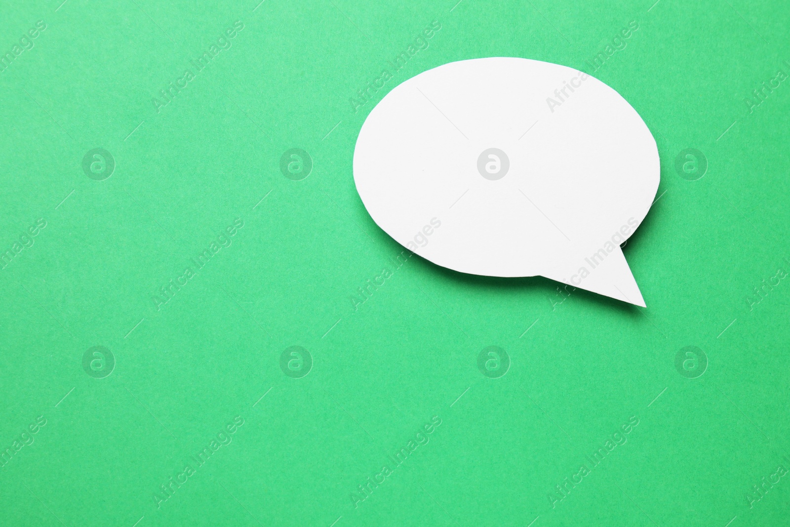 Photo of Blank speech bubble on green background. Space for text