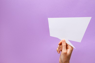 Photo of Woman holding blank speech bubble on lilac background, closeup. Space for text