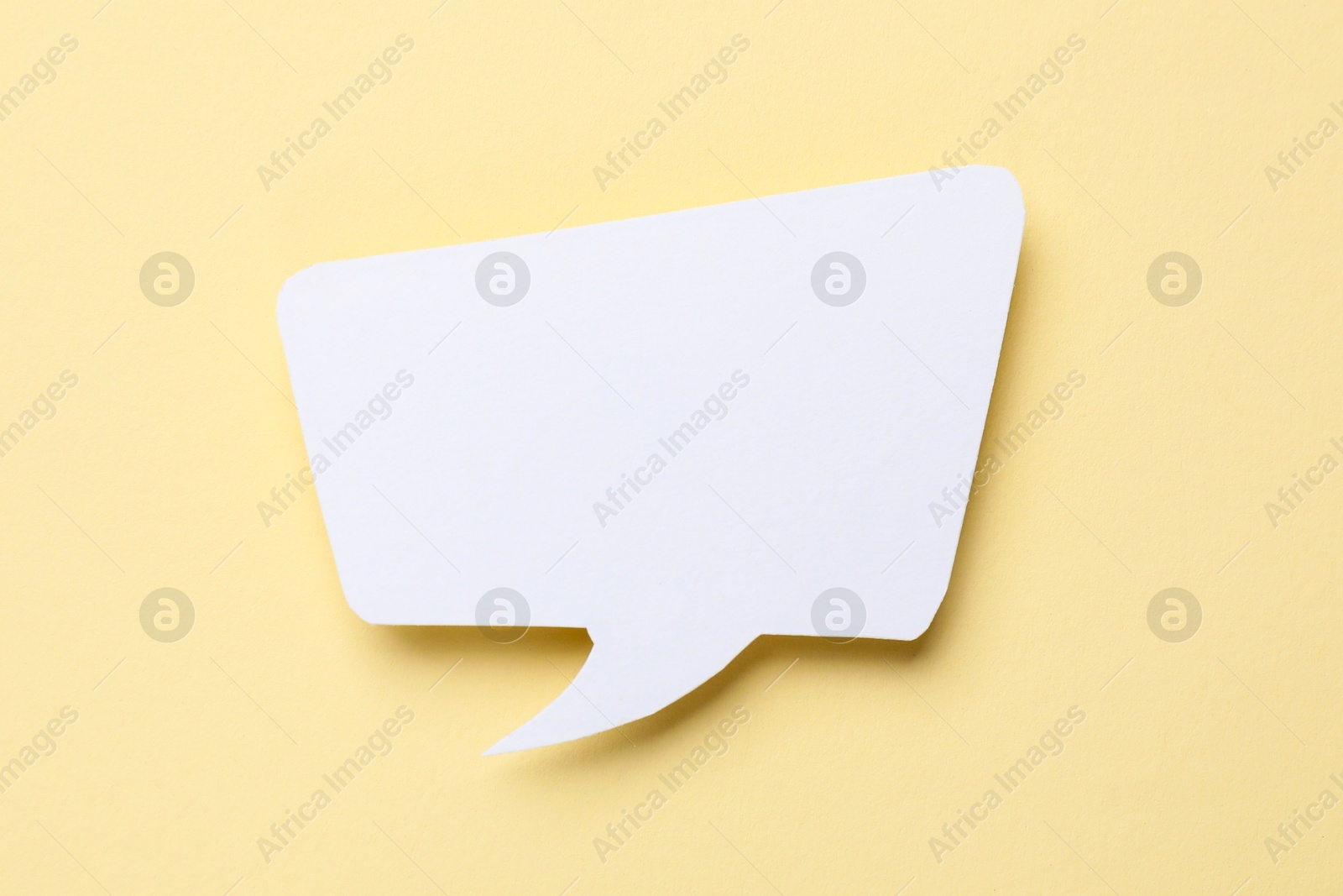 Photo of Blank speech bubble on beige background. Space for text