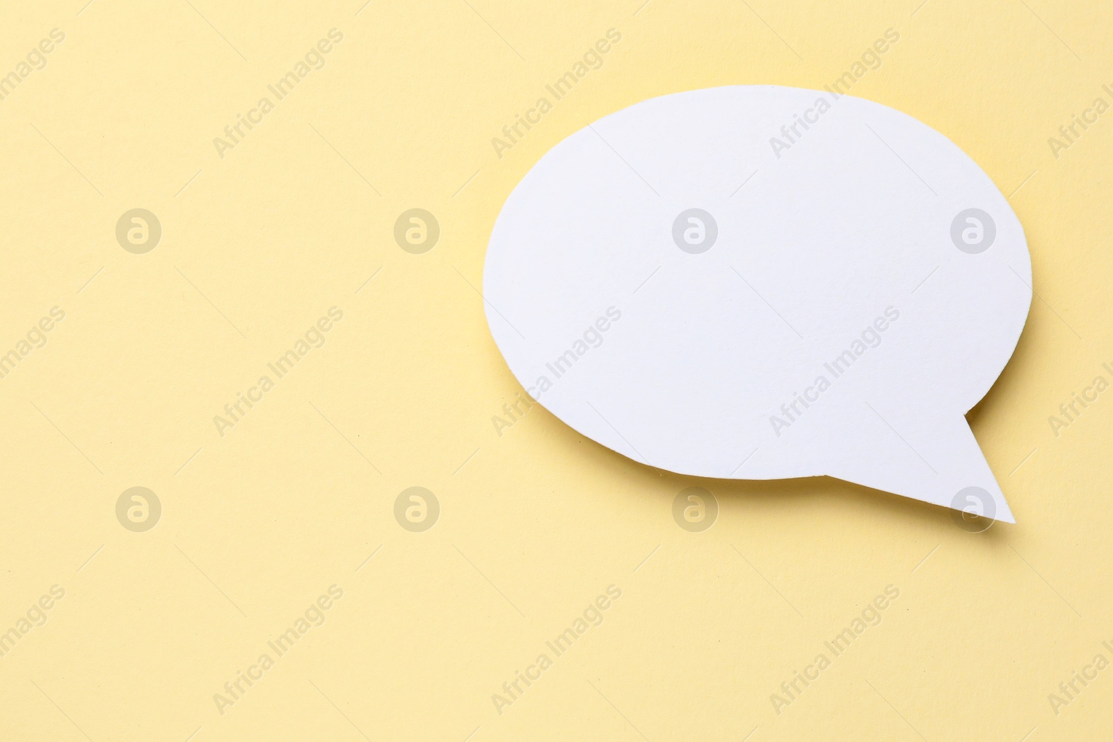 Photo of Blank speech bubble on beige background. Space for text