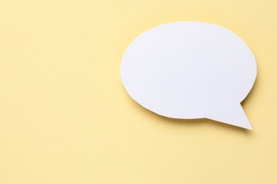 Photo of Blank speech bubble on beige background. Space for text