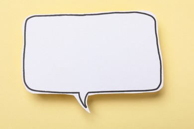 Photo of Blank speech bubble on beige background. Space for text