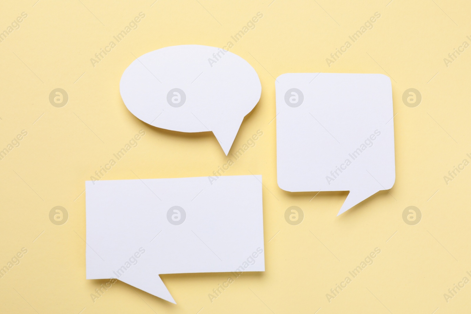 Photo of Blank speech bubbles on beige background. Space for text