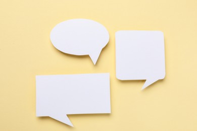 Photo of Blank speech bubbles on beige background. Space for text