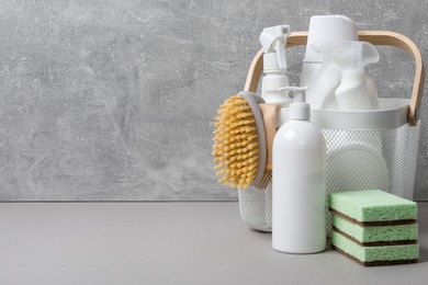 Photo of Eco-friendly cleaning products and supplies on grey table, space for text