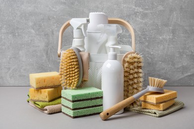 Photo of Eco-friendly cleaning products and supplies on grey table