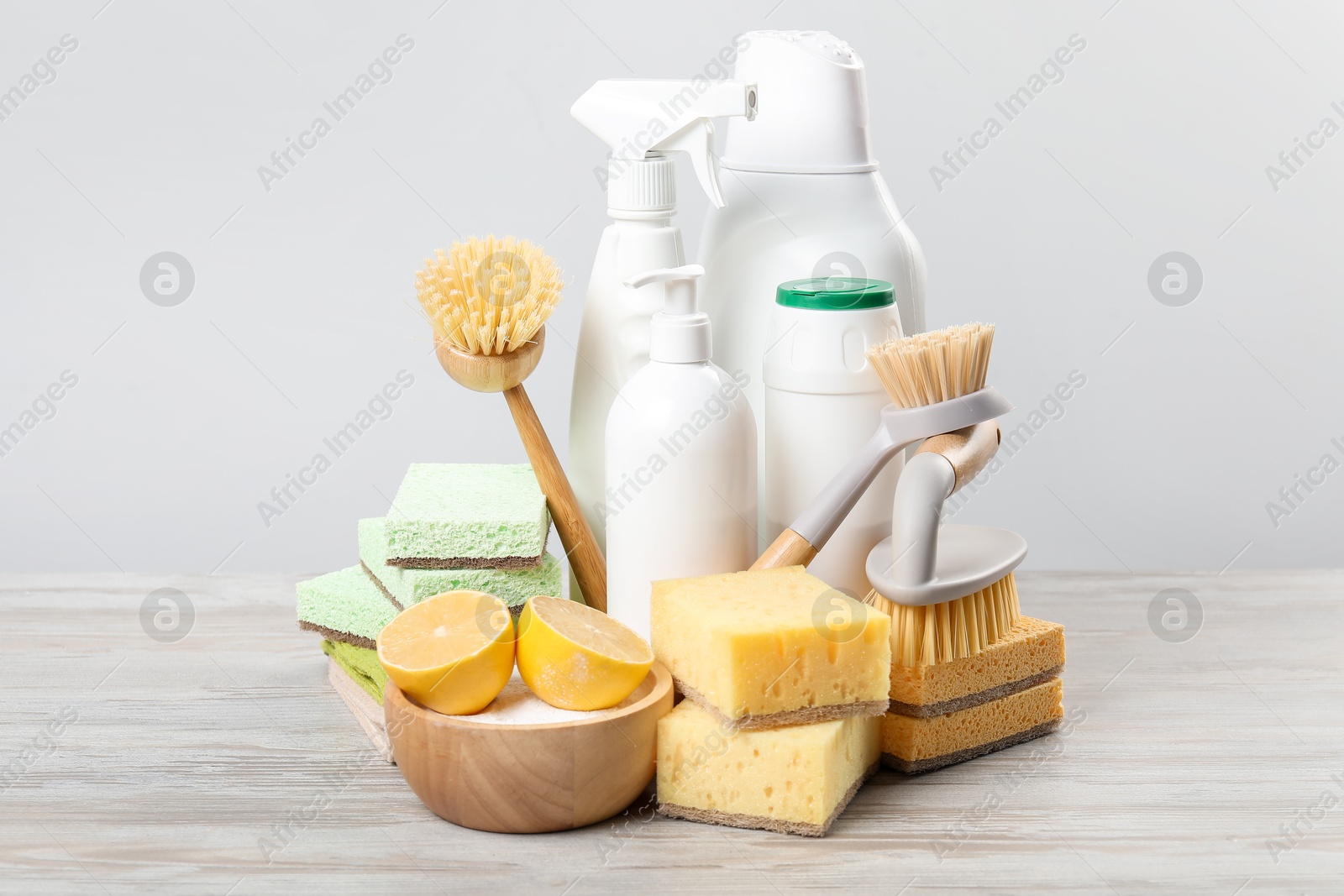 Photo of Eco-friendly cleaning products and supplies on wooden table