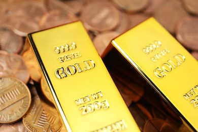 Photo of Gold bars on coins as background, closeup