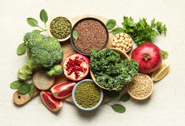 Photo of Different superfood products on light table, top view